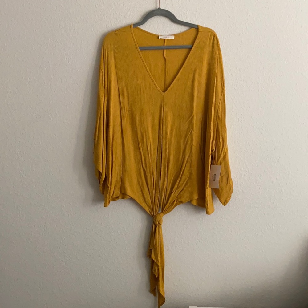 Boutique Mustard Tie Top. Oversized fit.
